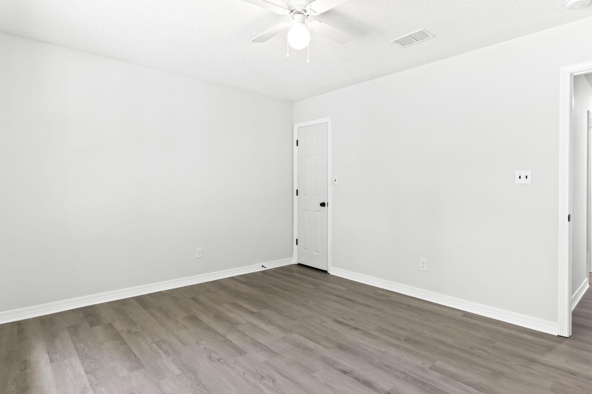 3650 Berrypatch Lane Pace, FL 32571 - Photo 32 of 53 an empty room with wooden floor and fan
