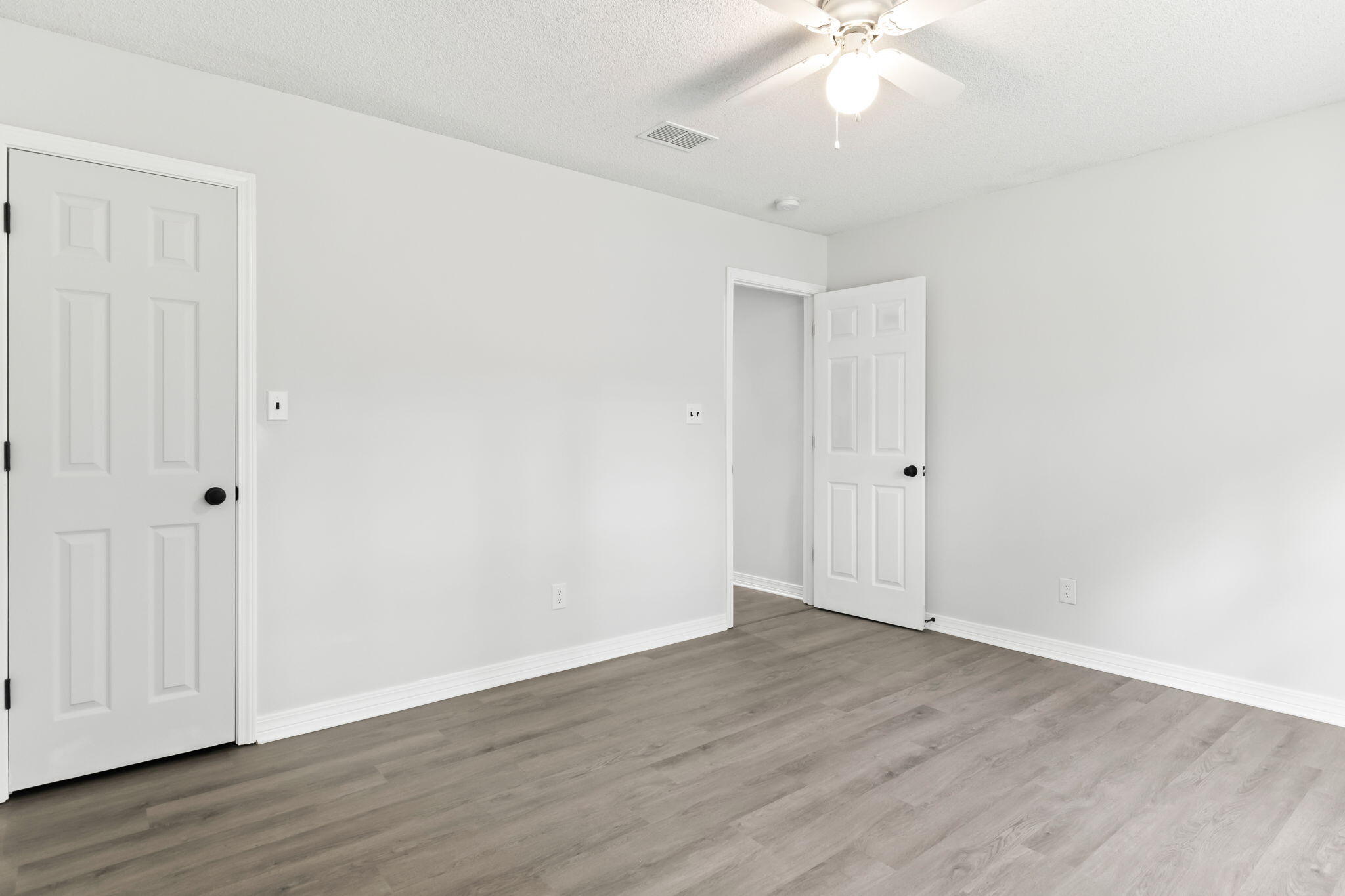 3650 Berrypatch Lane Pace, FL 32571 - Photo 33 of 53 an empty room with wooden floor and fan