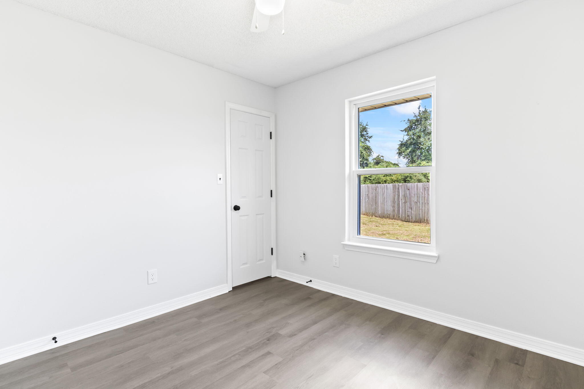 3650 Berrypatch Lane Pace, FL 32571 - Photo 36 of 53 an empty room with wooden floor and a window