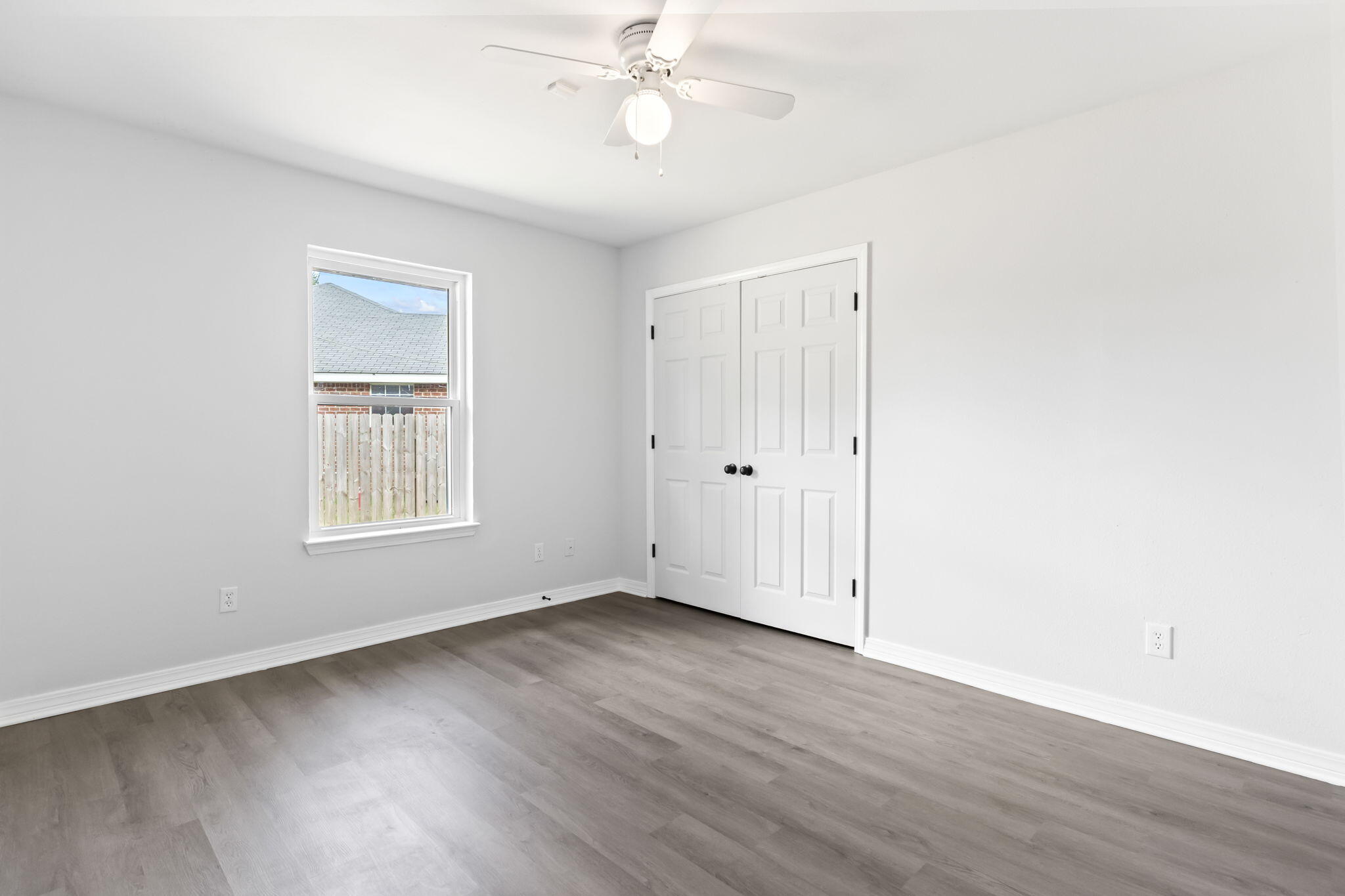 3650 Berrypatch Lane Pace, FL 32571 - Photo 39 of 53 an empty room with wooden floor closet and windows