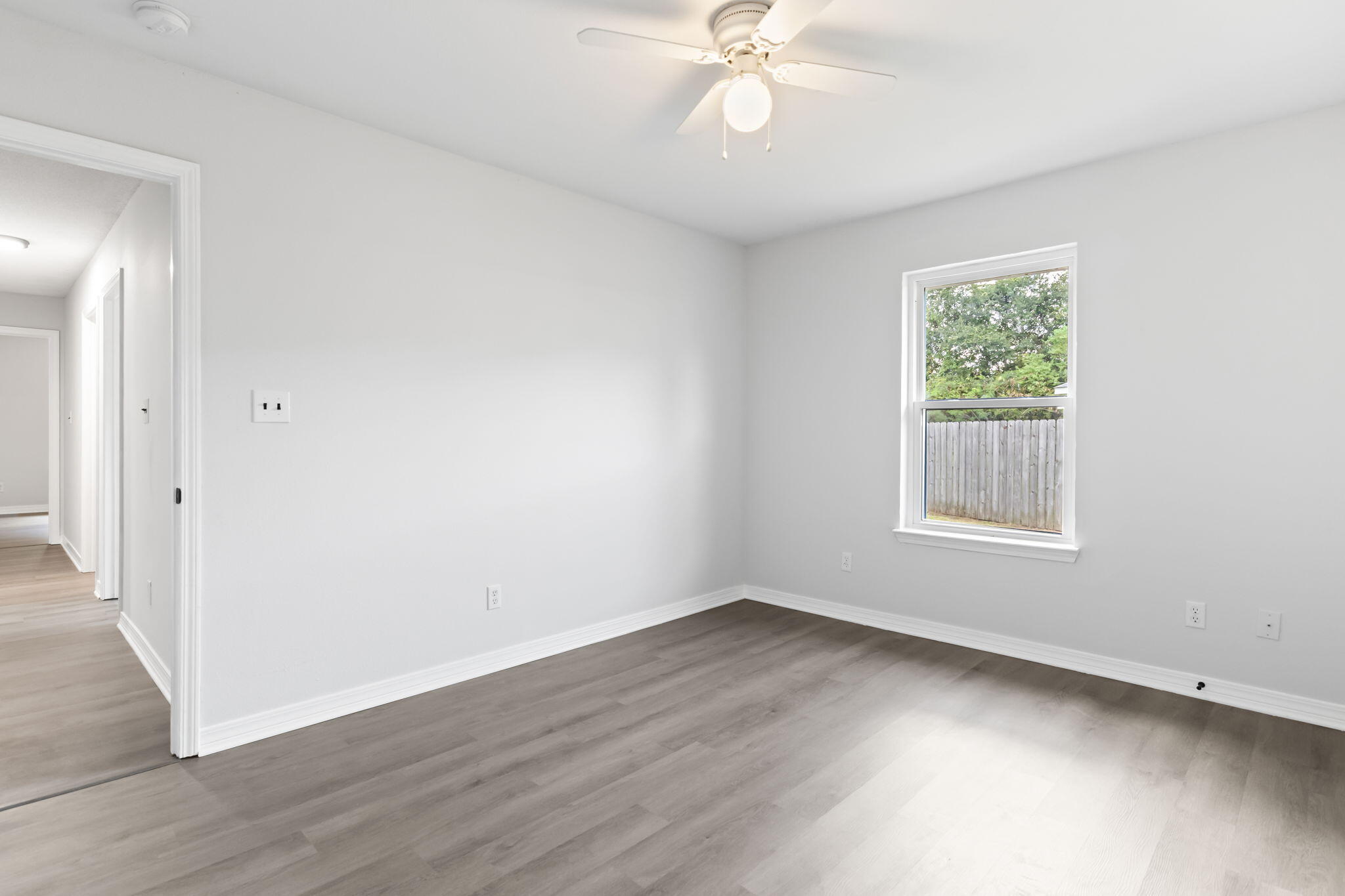 3650 Berrypatch Lane Pace, FL 32571 - Photo 40 of 53 a view of an empty room with wooden floor and a window