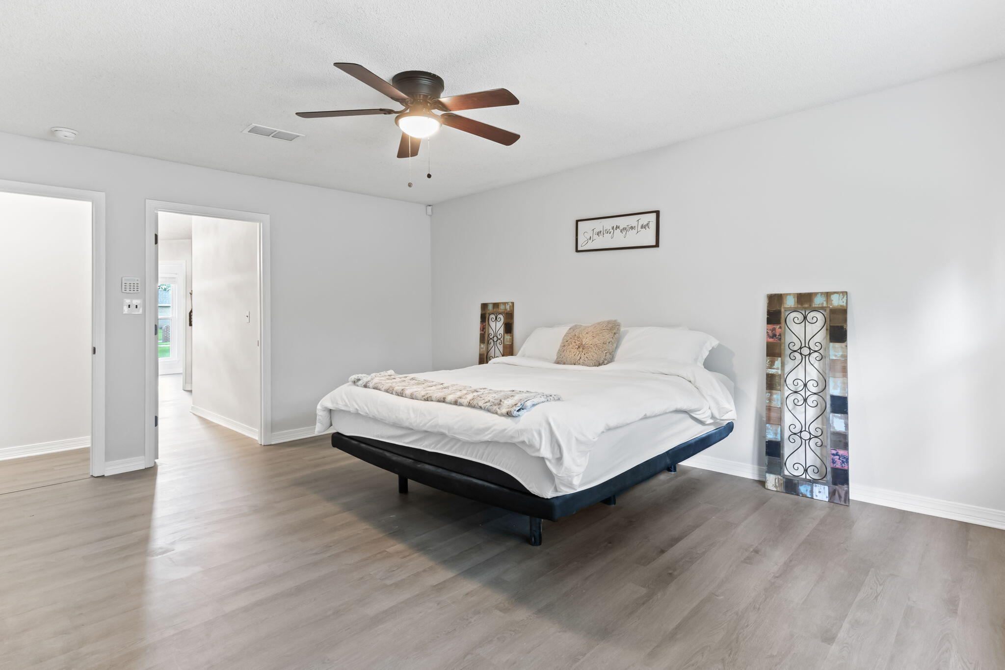 3650 Berrypatch Lane Pace, FL 32571 - Photo 4 of 53 a bedroom with a bed and a chandelier