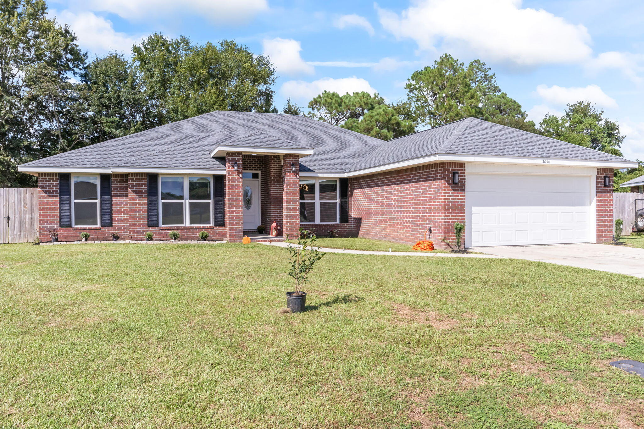 3650 Berrypatch Lane Pace, FL 32571 - Photo 52 of 53 a front view of a house with a yard and garage