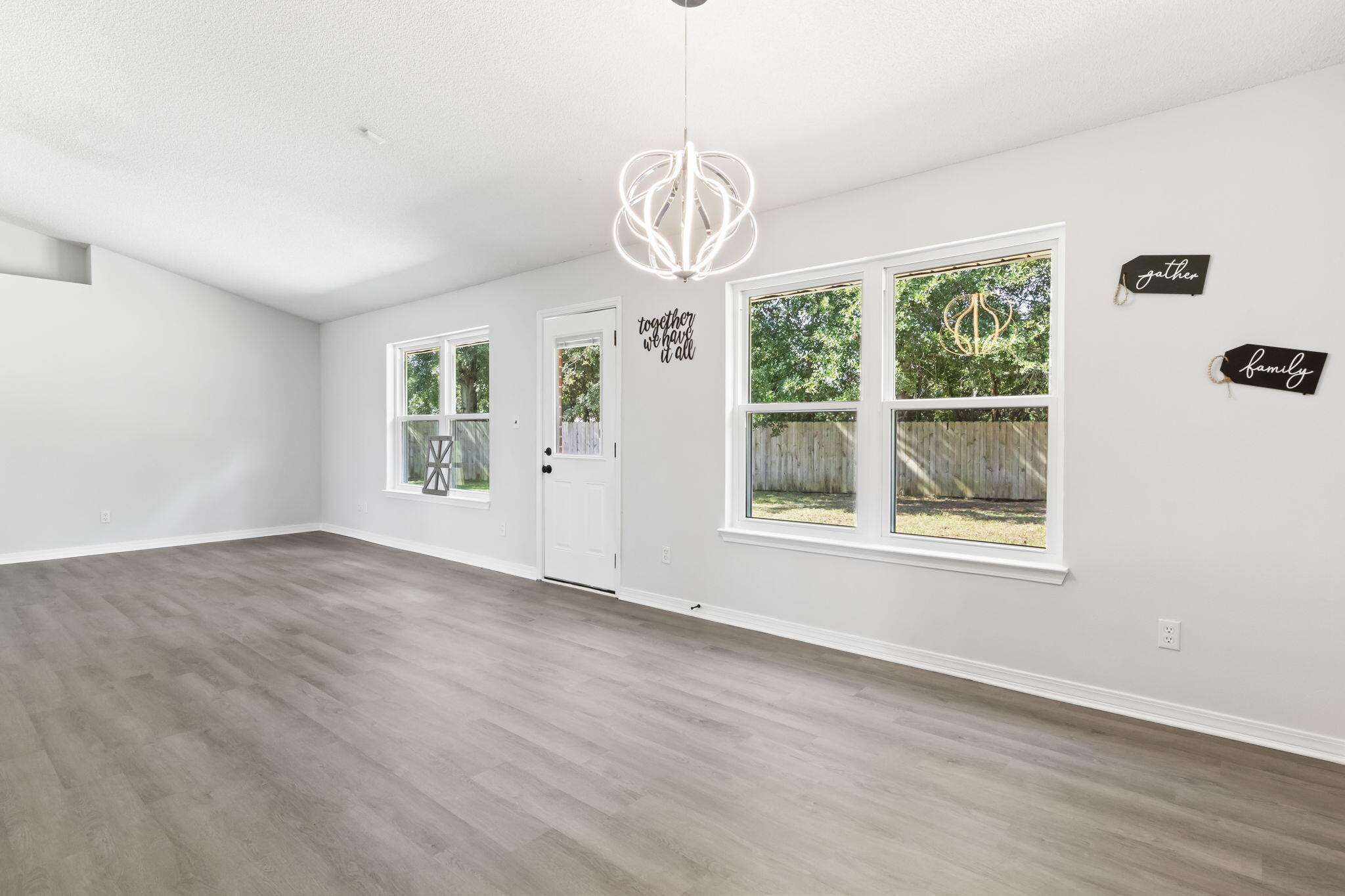 3650 Berrypatch Lane Pace, FL 32571 - Photo 9 of 53 an empty room with windows and ceiling fan