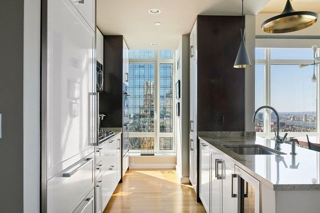 a spacious bathroom with a double vanity sink a mirror and a shower