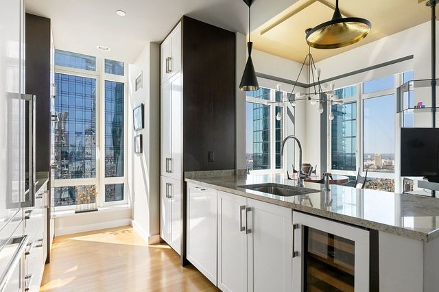 a bathroom with a double vanity sink mirror and shower
