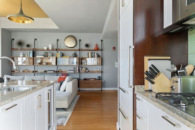 a kitchen with a sink and a stove top oven