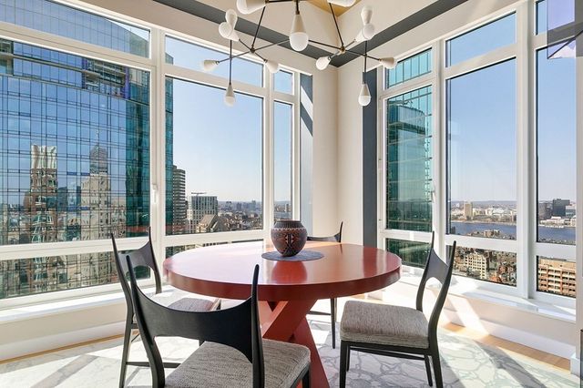 a view of a patio with a table chairs and a potted plant