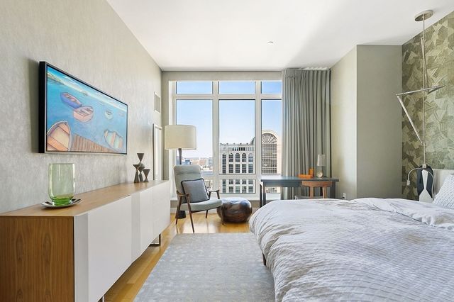 a bedroom with a bed and a large window