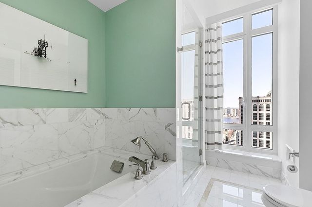 a bathroom with a bathtub and shower