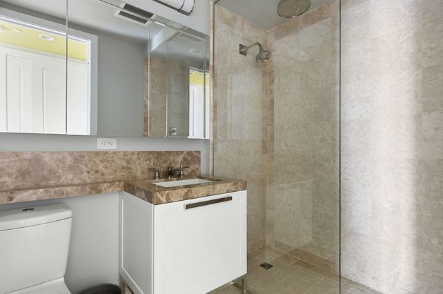 a bathroom with a sink a toilet and shower