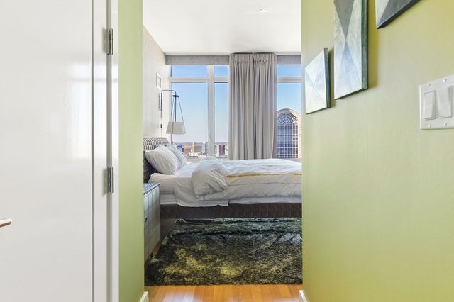 a bed room with a bed and a painting on the wall