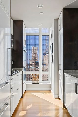 a view of open kitchen with a sink and a refrigerator