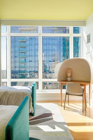 a living room filled with furniture and a floor to ceiling window