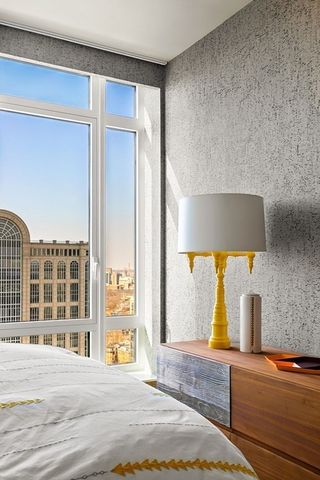 a bedroom with a bed and a night stand