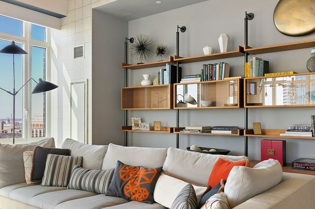 a living room with furniture and a book shelf