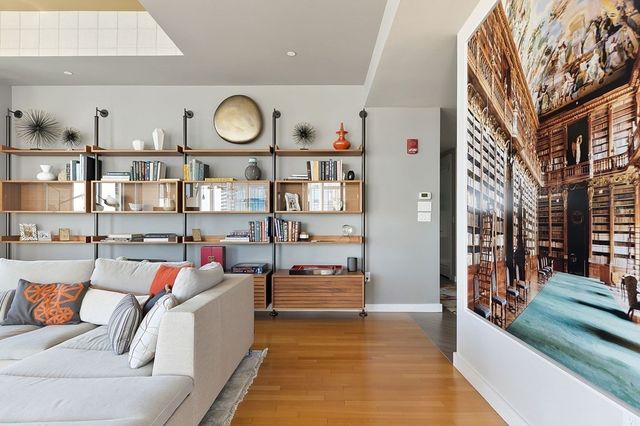 a living room with furniture and a clock