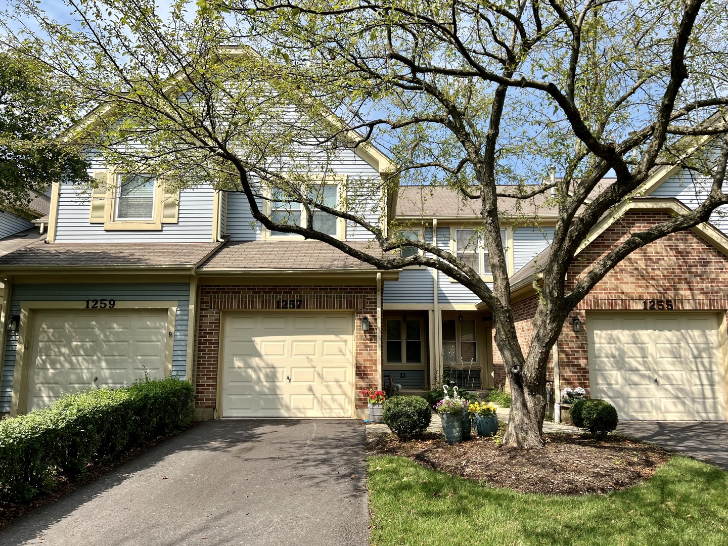 1257 Rhodes Lane Naperville, IL 60540 - Photo 1 of 24 a front view of a house with garden