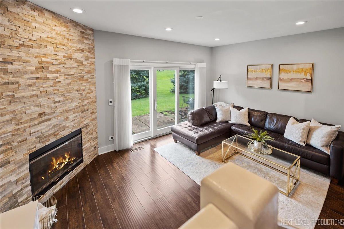 1257 Rhodes Lane Naperville, IL 60540 - Photo 11 of 24 a living room with furniture and a fireplace