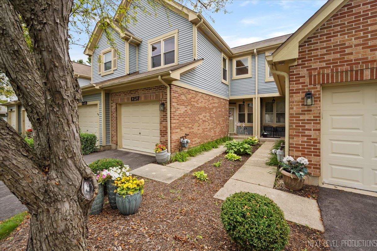 1257 Rhodes Lane Naperville, IL 60540 - Photo 2 of 24 a front view of a house with a yard
