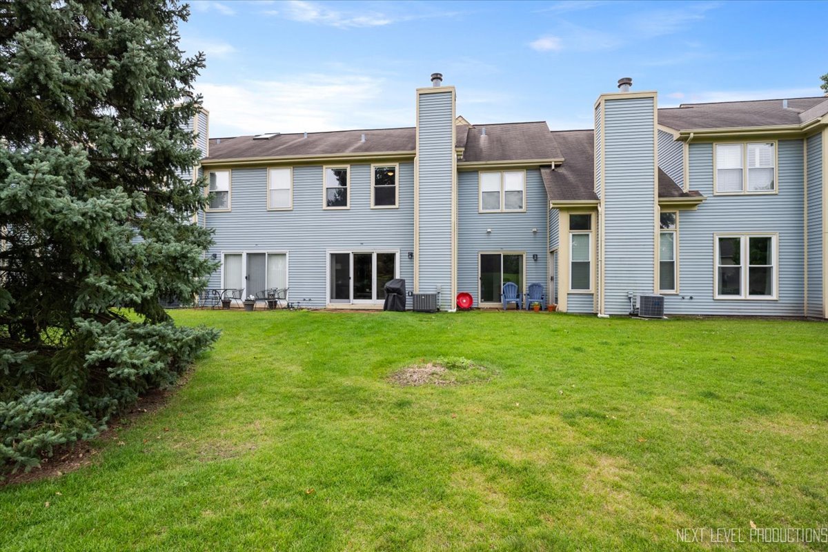 1257 Rhodes Lane Naperville, IL 60540 - Photo 23 of 24 a view of an house with backyard space and balcony