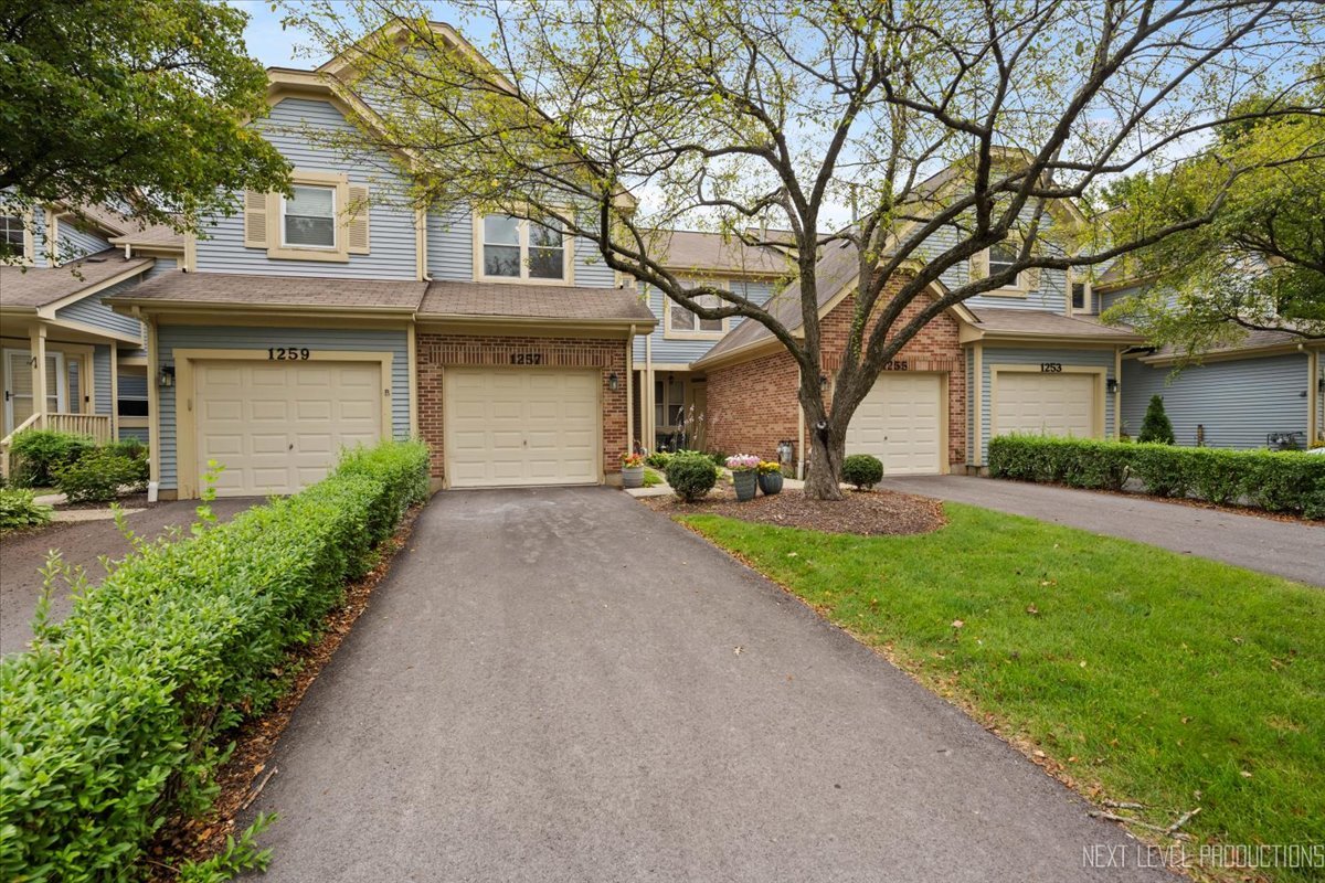 1257 Rhodes Lane Naperville, IL 60540 - Photo 24 of 24 a front view of a house with a yard and trees