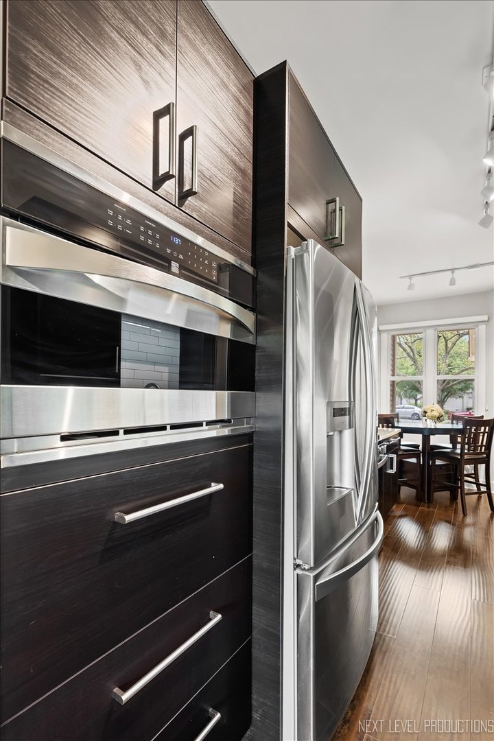 1257 Rhodes Lane Naperville, IL 60540 - Photo 5 of 24 a metallic refrigerator freezer sitting inside of a kitchen