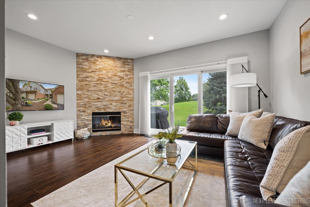 1257 Rhodes Lane Naperville, IL 60540 - Photo 7 of 24 a living room with furniture and a fireplace