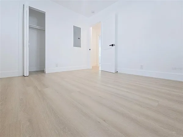 a view of an empty room and wooden floor