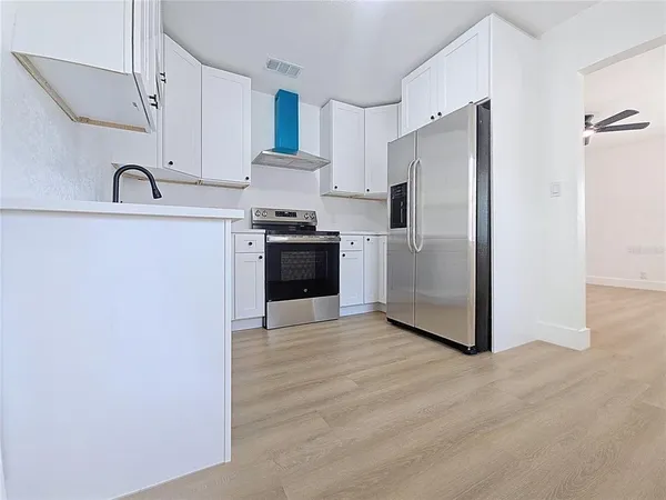 a kitchen with stainless steel appliances a refrigerator and a sink