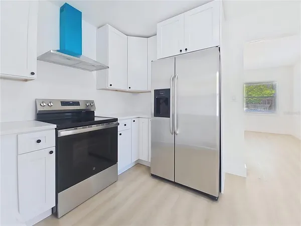 a kitchen with cabinets and stainless steel appliances