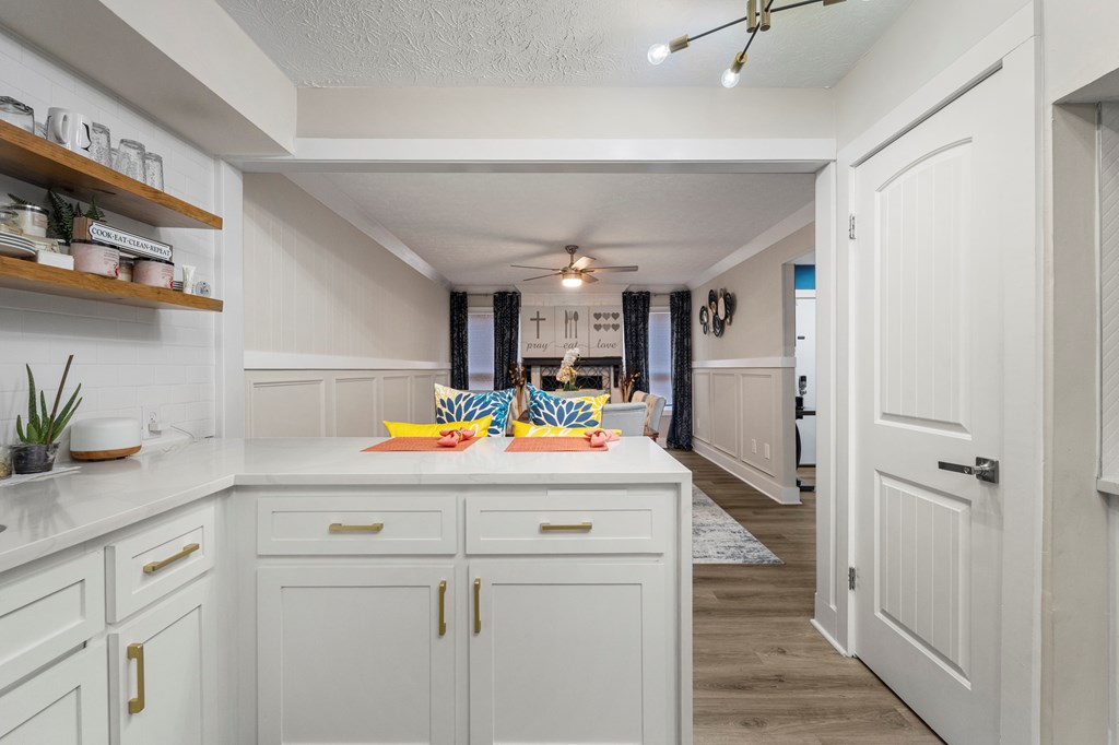 2525 Norris Road, Unit 38 Columbus, GA 31907 - Photo 12 of 27 a kitchen with kitchen island a sink a stove cabinets and wooden floor