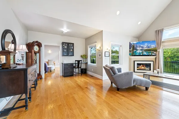 a living room with furniture a fireplace and a flat screen tv
