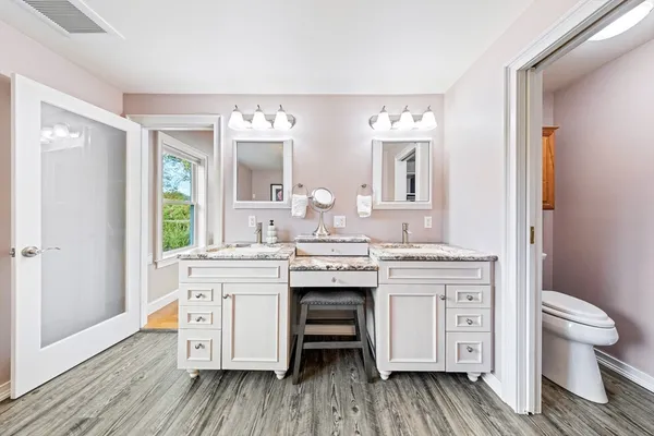 a spacious bathroom with a double vanity sink and a mirror