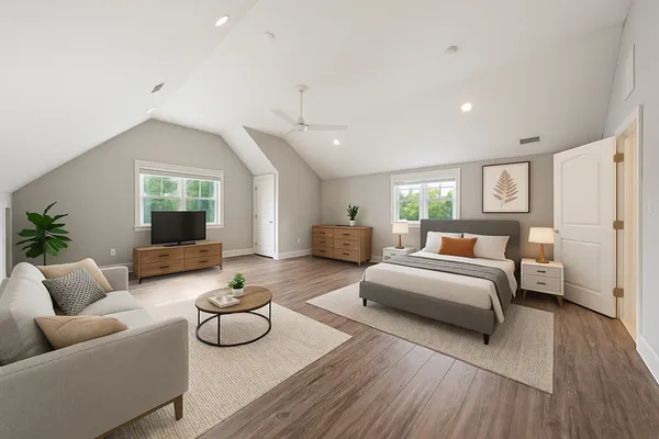 a living room with furniture and a wooden floor