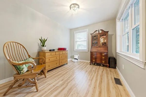 a dining room with furniture and wooden floor