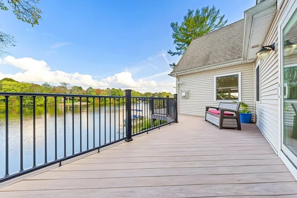 a view of a balcony with wooden floor and fence