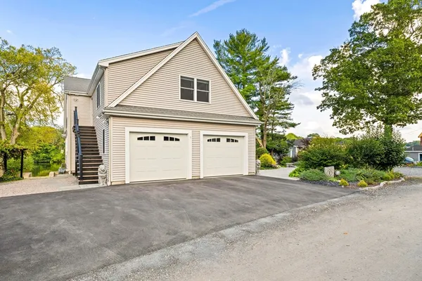 a front view of a house with a garage and a yard