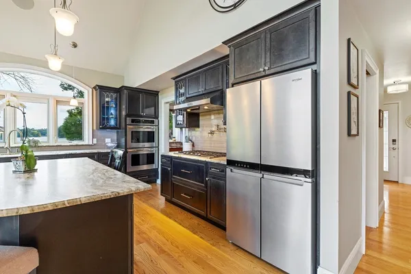 a kitchen with stainless steel appliances a refrigerator and a stove