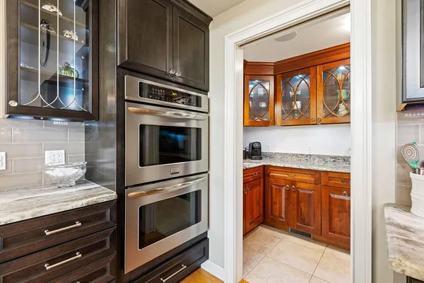 a kitchen with granite countertop cabinets stainless steel appliances and a counter top space