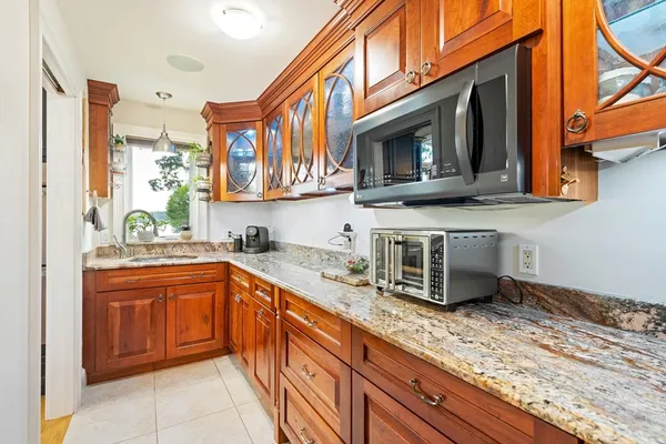 a kitchen with stainless steel appliances granite countertop a sink and a microwave