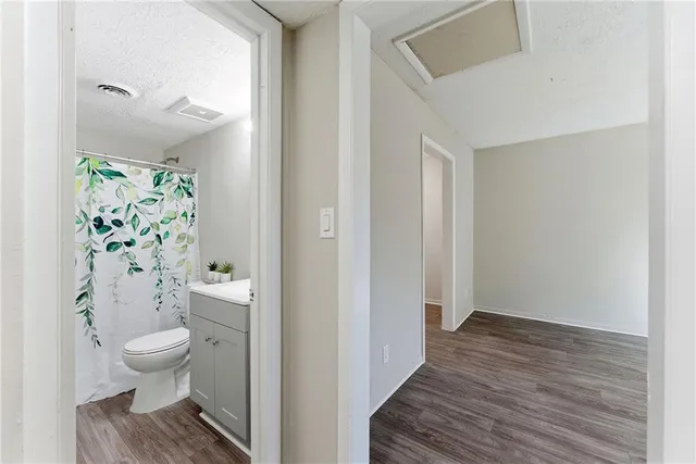a bathroom with a toilet and a shower