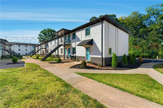 a view of a house with swimming pool and sitting area