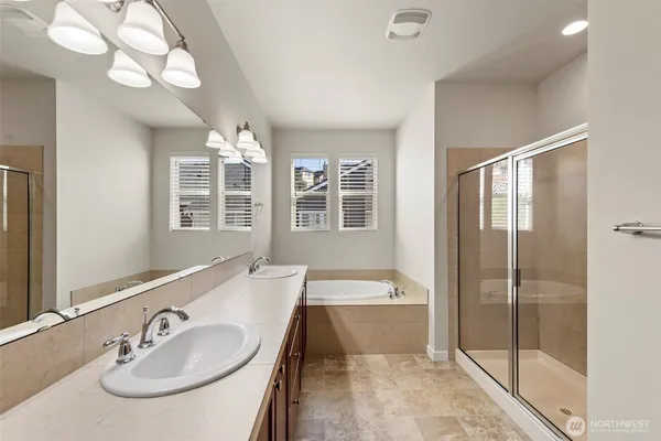 a bathroom with a tub sink and mirror