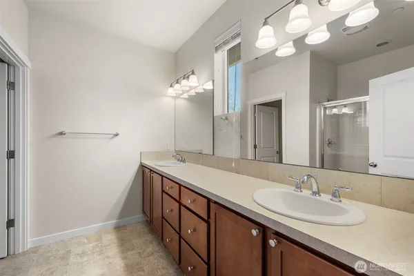 a bathroom with a sink a light fixture and a mirror