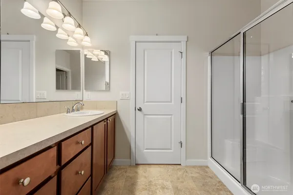 a bathroom with a sink vanity granite and a mirror