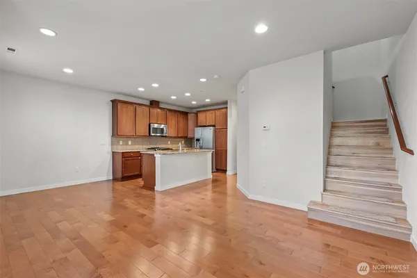a view of kitchen with kitchen island and stainless steel appliances