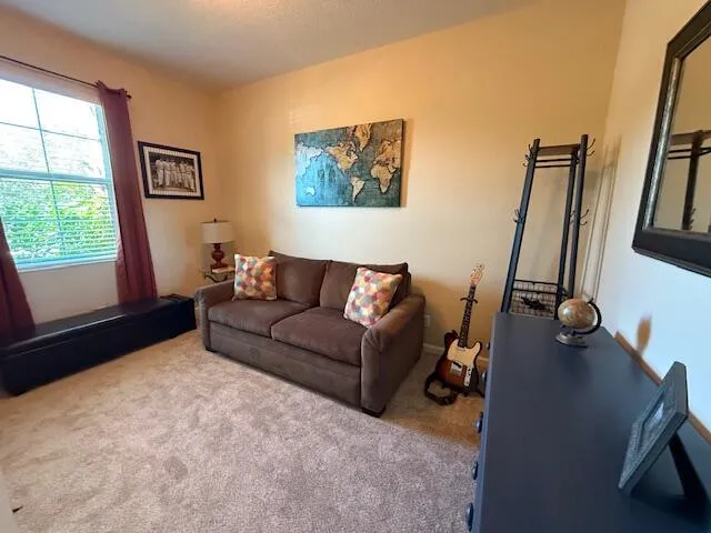 a view of a lake with a yard and large trees