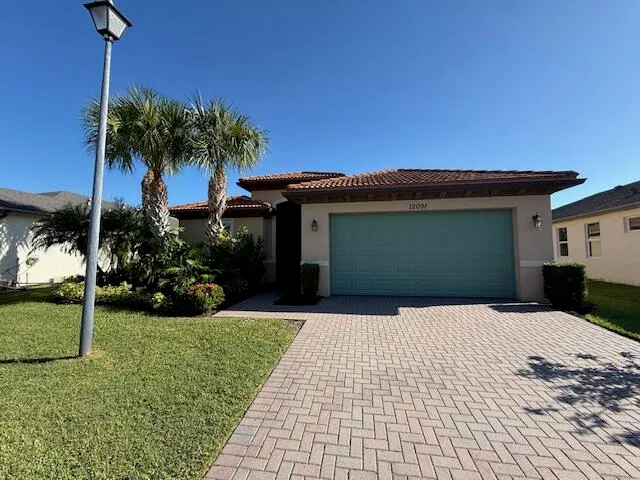 a front view of a house with a garden and yard