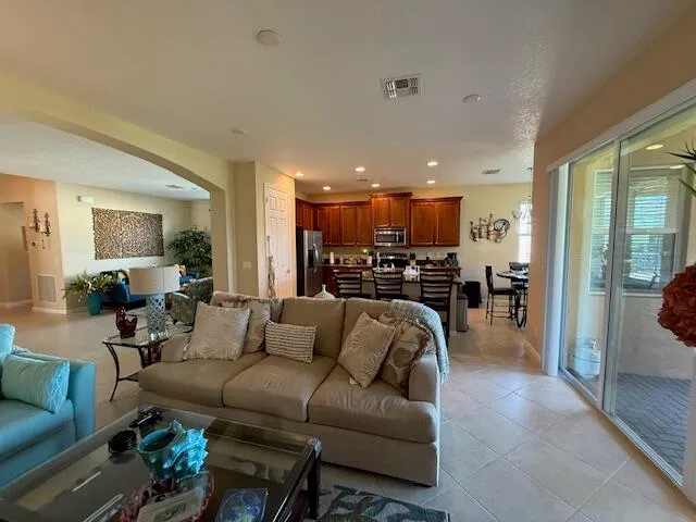 a living room with furniture chess board and a window